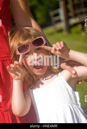 Modello di rilascio, Lustiges Maedchen mit Sonnenbrille - Funny Girl con ombrelloni Foto Stock