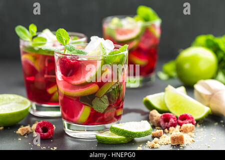 Lampone cocktail mojito con calce, la menta e il ghiaccio, il freddo bevanda rinfrescante Foto Stock