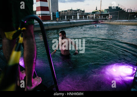 Danimarca, Copenaghen, 12 febbraio 2017. Piscina invernale i più temerari salta il ghiaccio acque del porto di Copenaghen pool come parte dell'evento "Ilddåb" durante l'arte danese e il festival di musica Frost Festival 2017 a Copenaghen. Nelle tenebre dell'inverno nuotatori furono incoraggiati a passare il coul acqua dal fuoco canoni illuminazione egli sky e fulmini interattiva in e al di fuori della piscina del porto. Credito: Gonzales foto/Alamy Live News Foto Stock