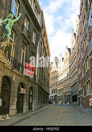 Anversa, Belgio - 26 Maggio 2011: La twisted Kaasstraat street con conserva edifici fiamminghi e la statua in bronzo di una donna in primo piano su Foto Stock