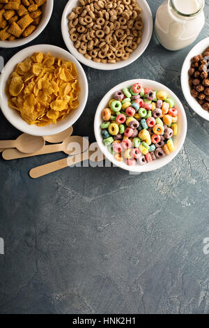 Varietà di cereali freddi in bianco bocce, veloce colazione per bambini overhead shot con copyspace Foto Stock