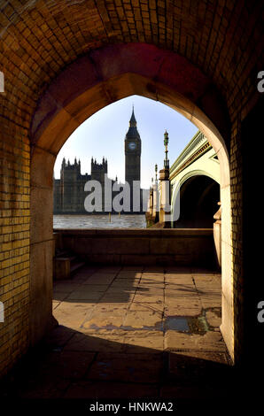 Londra, Inghilterra, Regno Unito. Il Big Ben e il Parlamento si vede attraverso un arco sotto Westminster Bridge Foto Stock