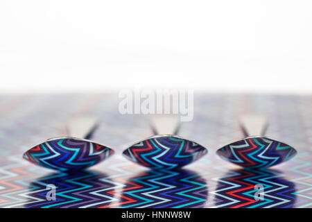 3 cucchiai di zuppa con riflessione colorati Foto Stock