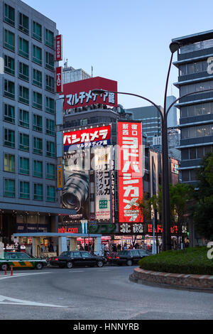 TOKYO, Giappone - CIRCA APR, 2013: Contemporanea edifici illuminati con un sacco di banner sono nel quartiere di Shinjuku di notte tempo. Taxi parking lot. S Foto Stock