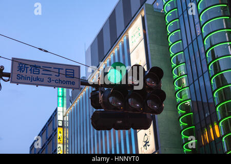 KAMAKURA, Giappone - CIRCA APR, 2013: semaforo è su strada nel centro della città nel quartiere di Shinjuku in serata. Shinjuku è una grande pubblicità c Foto Stock