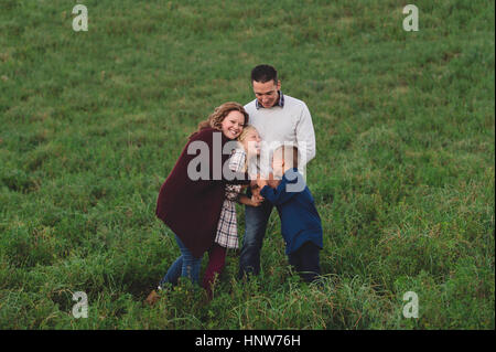 La famiglia nel campo avvolgente Foto Stock