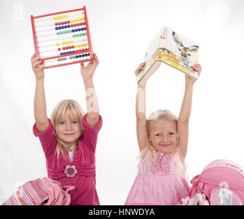 Modello di rilascio, Zwei Schulmaedchen mit Lesebuch und Abakus - due studentesse con libro e abacus Foto Stock