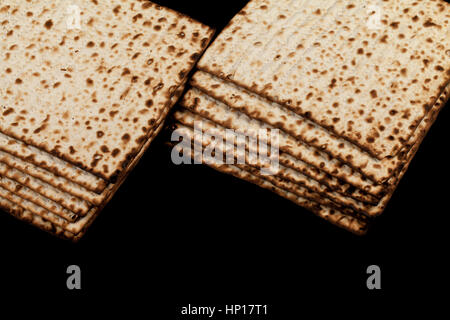 Tradizionale matzah ebraico su uno sfondo nero. Close-up Foto Stock