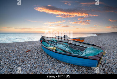 Tramonto su barche da pesca a Chesil Beach sull'isola di Portland vicino a Weymouth nel Dorset Foto Stock