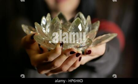 Giovane donna dà un crystal lotus dal suo cuore Foto Stock