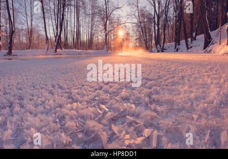 Inverno il sole brilla su di cristalli di ghiaccio. Sfondo con modelli di ghiaccio. Colorato sfondo d'inverno. Close-up di modelli di ghiaccio nella luce del sole di mattina. Foto Stock