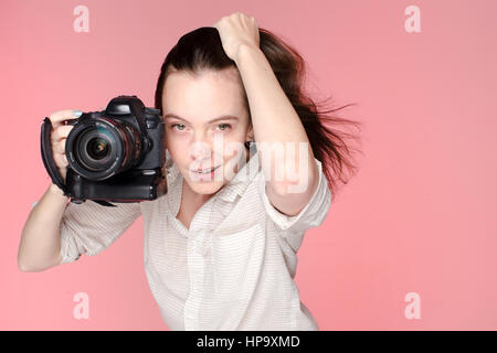 Ritratto della ragazza con la fotocamera in mano destra Foto Stock