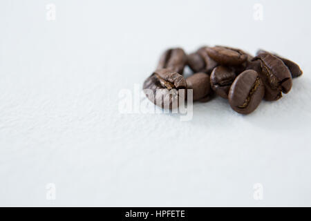 Chicchi di caffè tostati su sfondo bianco Foto Stock