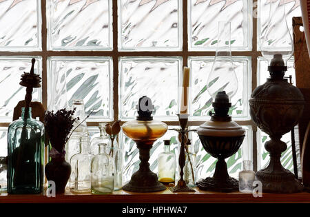 Olio d'annata di raccolta della lampada nella parte anteriore del vetro di un muro di mattoni Foto Stock
