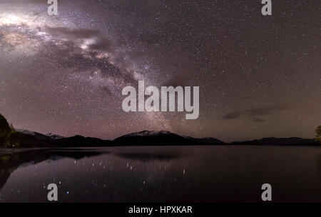Scena Notturna, lago Wanaka con le stelle e la Via Lattea, stelle mirroring nell'acqua, Glendhu Bay, Otago Southland, Nuova Zelanda Foto Stock