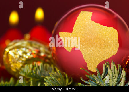 Un rosso lucido ninnolo con la forma d'oro del Texas.(serie) Foto Stock