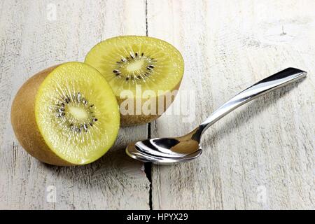 Golden kiwi ione sullo sfondo di legno Foto Stock