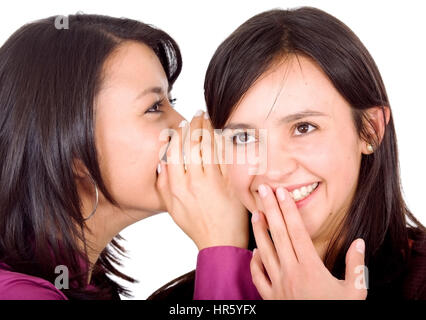 Ragazza raccontando un segreto ad un altro - gossip isolate su uno sfondo bianco Foto Stock