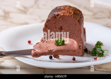 Speciale il patè di fegato costituito da diversi tipi di carne con grani di pepe sul coltello Foto Stock