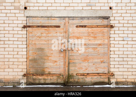 Vecchio weathered garage in legno porta bloccata con un lucchetto Foto Stock