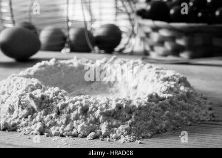 Immagine in bianco e nero della preparazione della pasta in una cucina italiana con farina e uova Foto Stock