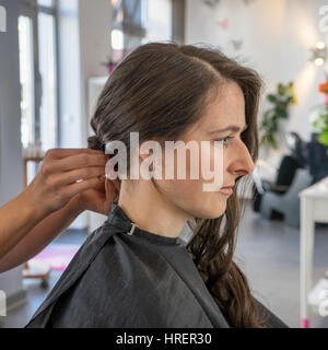 Una bellissima donna in un salone di parrucchiere Foto Stock