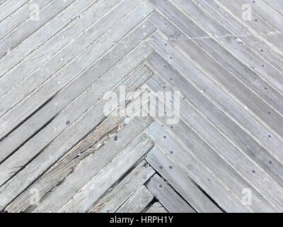 Chevron pattern in piante di legno su una passerella a Coney Island New York. Weathered assi inchiodati insieme in forma triangolare. Legno, testurizzato indietro Foto Stock