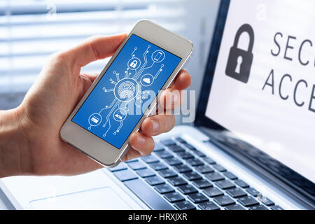 Mobile phone cyber security concept with a person showing smartphone screen, cybersecurity diagram and icons with microchip shape and fingerprint biom Foto Stock