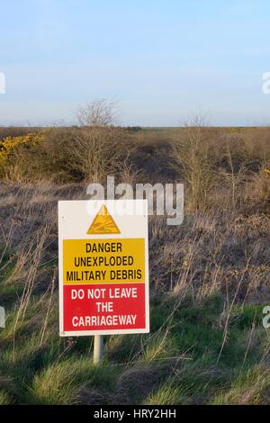 Segnale di avvertimento accanto a via attraverso M.O.D poligoni di tiro, Salisbury Plain, Wiltshire, Regno Unito, aprile 2015. Foto Stock