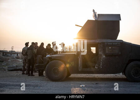 Athba, Ninive, Iraq. Il 27 febbraio, 2017. Ufficiali e uomini arruolati di Alfa Bravo e aziende, Battaglione Selahudeen stand da un up-armored Humvee vicino a loro HQ in Athba, Ninevah, Iraq, 27 febbraio 2017. Selahudeen e unità genitore, ISOF 2, è uno degli elementi di assalto con il compito di assistere nella liberazione della metà occidentale di Mosul da ISIS. Credito: Nish Nalbandian/ZUMA filo/Alamy Live News Foto Stock