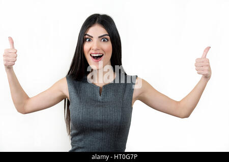 Giovane donna di affari molto entusiasti che mostra Thumbs up. Foto Stock