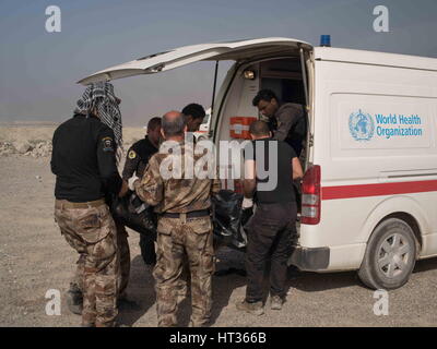 Mosul, Ninive, Iraq. 1 Mar, 2017. Irachena Forze Speciali medic caricare il corpo di un soldato ucciso in azione in un ambulanza a una divisione aiuto dalla stazione di Ghazlani, Mosul, Iraq, 1 marzo 2017. Il soldato compagni, dal battaglione Najjaf, ha chiesto che la sua identità non può essere rilasciato e ha detto che è stato ucciso in pesanti scontri a Wadi Najjar. Credito: Nish Nalbandian/ZUMA filo/Alamy Live News Foto Stock