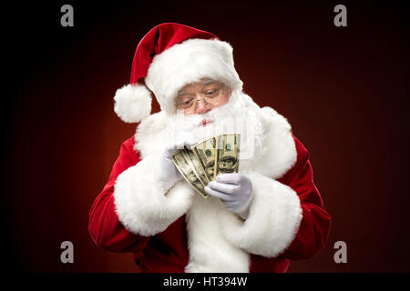 Santa Claus conteggio banconote di dollari Foto Stock
