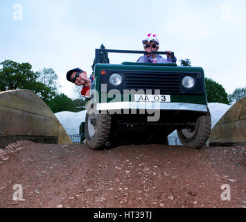 Bambino la guida un giocattolo di Land Rover. Artista: sconosciuto. Foto Stock