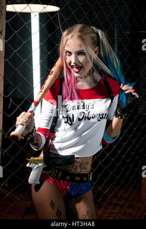 Ragazza in costume Harley Quinn. Essa si erge con bat e pistola. Close up.  Cosplay Foto stock - Alamy