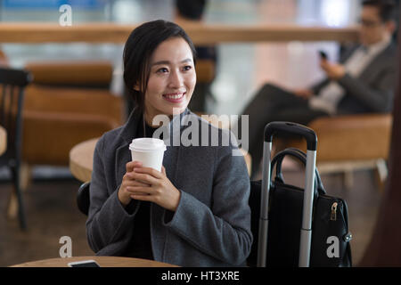 Imprenditrice in attesa in aeroporto Foto Stock