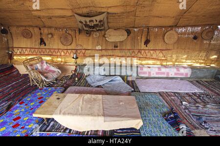 Camera tradizionale Caravanserai del Villaggio Farafra. Letto d'antiquariato personalizzato con tappeto e tappeto decorato a mano. Sosta per riposare nell'oasi del deserto bianco egiziano Foto Stock