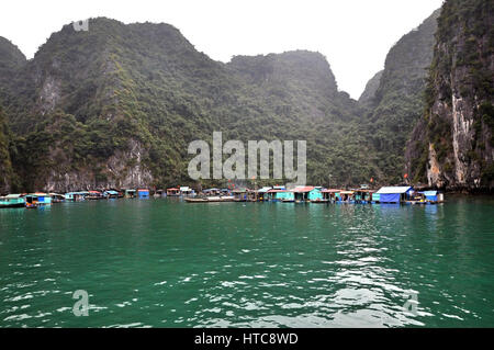 HALONG BAY - Feb 27: galleggiante villaggio di pesca nella baia di Halong visitato da turisti. Halong Bay è parte dell'Unesco e una delle Nuove Sette Meraviglie naturali Foto Stock