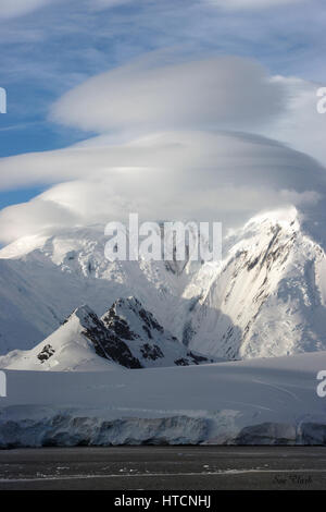 La luce solare colpisce le montagne coperte di neve sulla penisola Antartica come si vede dalla nave sul nostro expedition cruise. Foto Stock