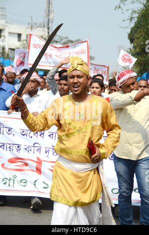 Nagaon, Assam. Decimo Mar, 2017. Un membro di di AASU in abito tradizionale con una spada in mano marzo fuori 'Satyagrha'rally Nagaon nel distretto di Assam Venerdì, protestando contro la vandalising di AASU ufficio in Silapthar da una organizzazione bengalese lunedì. Credito: DIGANTA TALUKDAR/Alamy Live News Foto Stock