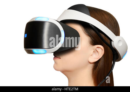 Donna che indossa una Playstation Sony Cuffie VR contro uno sfondo bianco. Foto Stock