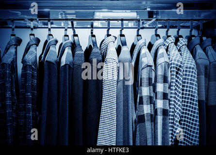 Mens plaid camicie su appendiabiti in un negozio al dettaglio Foto Stock