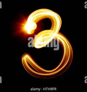 Tre - creato da numeri di luce su sfondo nero Foto Stock