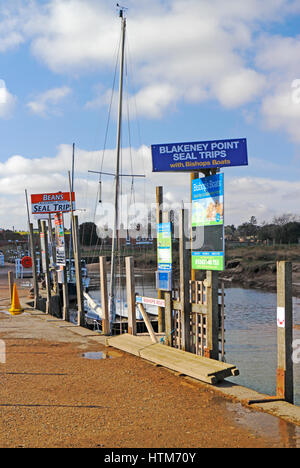 Le indicazioni per le gite in barca Seal per Blakeney Point sulla banchina nel Nord Norfolk a Blakeney, Norfolk, Inghilterra, Regno Unito. Foto Stock