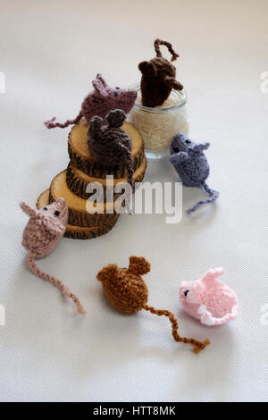 Strano concetto dal prodotto artigianale, gruppo di piccoli topi mangiano riso, splendidi animali giocattoli per bambini, ratti a maglia lavorato a maglia di filati Foto Stock