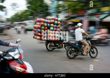 HO CHI MINH, VIET NAM- MAR 30: Unsafe, pericolo di trasporto su strada vietnamita, uomo ride moto, trasporto merci in sovraccarico, voluminoso, Foto Stock