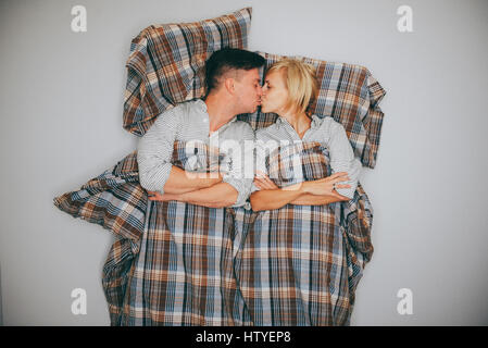 Giovane giacente sul piano kissing Foto Stock