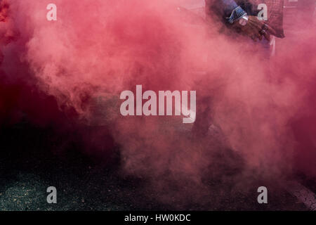 Madrid, Spagna. 16 marzo 2017. Un manifestante con anelli cranio passando attraverso una bomba fumogena durante una dimostrazione di conducenti di taxi contro servizi privati quali noi Uber e Cabify Credito: Marcos del Mazo/Alamy Live News Foto Stock