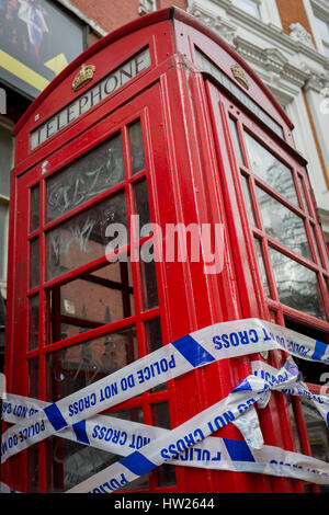 La polizia della scena del crimine il nastro avvolto intorno a un telefono rosso scatola in Soho il 8 marzo 2017, quartiere londinese di Westminster, Inghilterra. Foto Stock