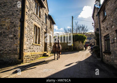 Lone rider in Castleton Derbyshire cavalcando attraverso il villaggio del sole in questa giornata calda Ray Boswell Foto Stock